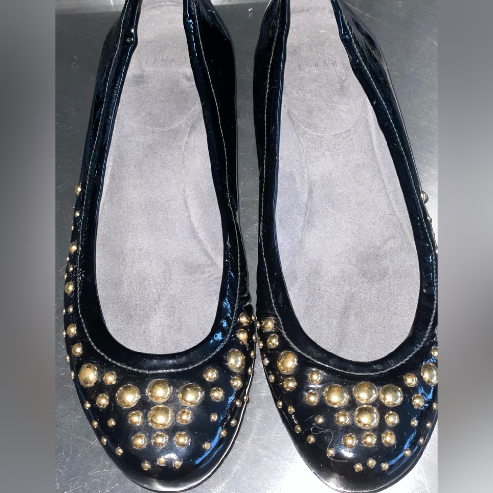Stuart Weitzman Flats. Black patent Leather, with gold colour studs.